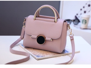 Detail of lavender litchi leather handbag with round metal handle and black gold disc lock