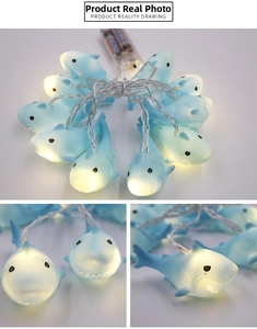 Detail view of 10 LED shark string lights with warm yellow glow and transparent battery box