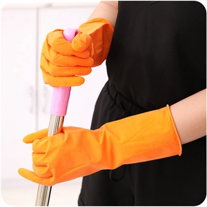Orange latex household cleaning gloves in size M shown holding a mop for kitchen chores