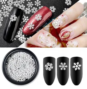 Detailed view of white snowflake nail art sequins in three styles with round box packaging