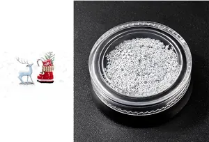 Detailed view of white snowflake nail art sequins in a transparent round jar container
