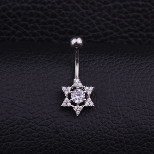 Macro shot of silver stainless steel navel ring with hexagram pendant and cubic zirconia
