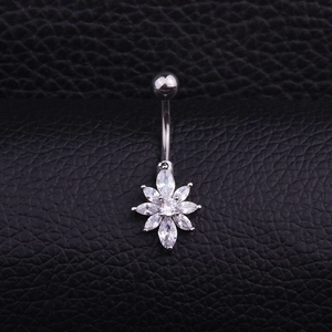 Detailed view of flower-shaped belly button ring with sparkling cubic zirconia on black leather