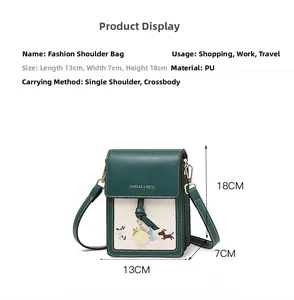 Detailed view of bicolor mini bag with dog embroidery and metal charm with dimensions