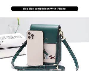Detail view of mini crossbody bag showing dog embroidery and size compared to a smartphone