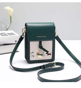 Detail of green and beige mini crossbody phone bag with dog embroidery and metal charm