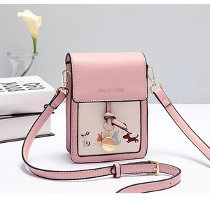 Detail of pink and beige mini crossbody bag with cute dog embroidery and gold logo