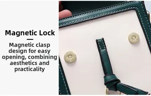 Detail view of dual magnetic closures on a green and beige patchwork leather mini bag