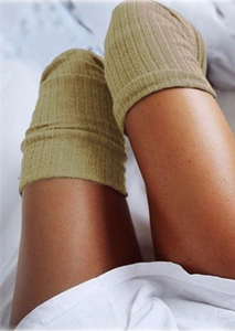 Detailed view of khaki ribbed knit over-the-knee socks showing texture and elasticity