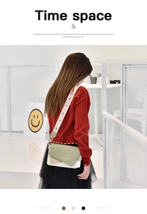 Detail of trendy color-block crossbody bag with wide ethnic embroidered shoulder strap