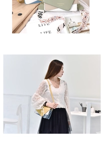 Detail of multi-color small square bag featuring a wide embroidered strap and leather finish