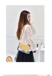 Detail of color-block leather crossbody bag with yellow flap and slim shoulder strap