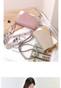 Detail of sweet small square bags with colorful embroidery LOVE straps and leather handles