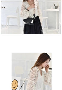 Detail of black and white color-block envelope bag with floral jacquard strap and metal hooks