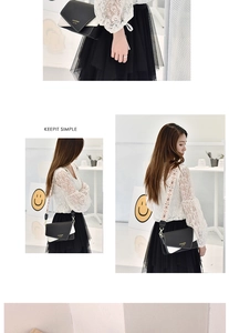 Detail of contrast color crossbody bag with ethnic floral embroidery wide strap on model