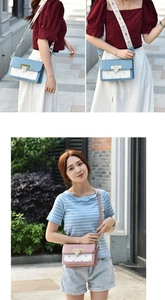 Gros plan détaillé du petit sac bandoulière tendance avec broderie cœur et fermoir doré