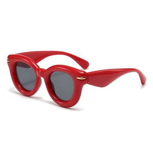 Fashionable red bubble sunglasses with thick frame and gold details from a 45-degree angle