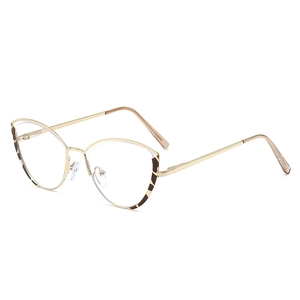Golden cat eye metal glasses frame with leopard pattern accents on white background