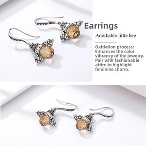 Detailed view of s925 silver bee earrings with amber crystal in vintage oxide finish