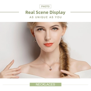 Close-up of a silver bee jewelry set with amber crystal details worn by a model