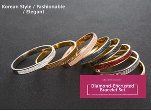 Close-up of stacked stainless steel bangles with sparkling crystals in six assorted colors