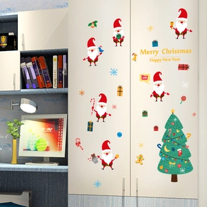 Self-adhesive Christmas window stickers featuring Santa Claus and tree on white furniture