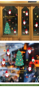 Detail of Christmas window decals featuring Santa Claus and tree on a glass door