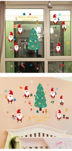 Detailed view of Merry Christmas window stickers showing Santa and tree on glass surface