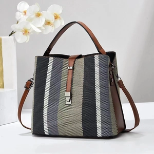 Retro striped handbag with brown leather accents and top handle for elegant women