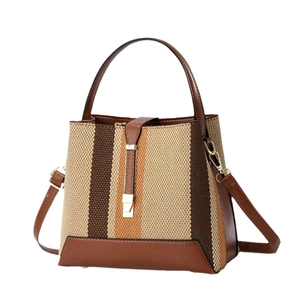 Minimalist woven tote bag in brown leather and earth tone striped fabric with gold hardware