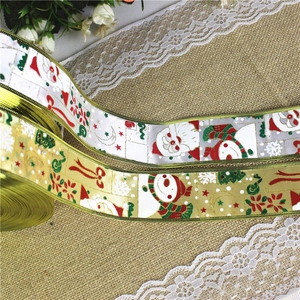 Detailed view of Christmas ribbons with Santa and snowman patterns on burlap background