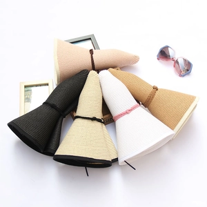 Various wide-brim straw sun hats in pink, black, beige, and white colors for women
