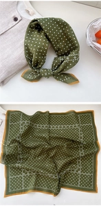 Close-up of dark green polka dot cotton scarf with yellow trim and floral patterns