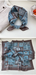 Detail of retro blue and brown square scarf with elephant print and silk-like texture