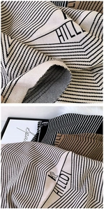 Detail of the knit texture and geometric pattern on the warm cashmere-like scarf