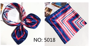 Detailed view of red, white, and blue striped satin scarf with French geometric pattern