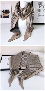 Close-up of double-sided diamond knit scarf with black stripes on beige background