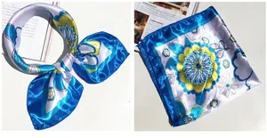 Macro detail of a 50cm vintage floral satin square scarf with bright blue border