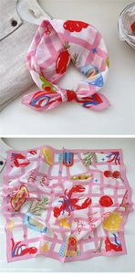 Detail of pink cotton square scarf with lobster and lemon print and Dolce Vita text