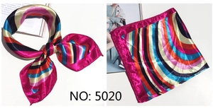 Detail of multi-color striped satin scarf folded into a bow with polished texture