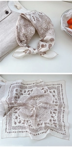 Close-up of cream cotton neckerchief with vintage dark brown paisley pattern texture