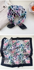 Detail view of cotton floral square scarf showing elegant pink flower pattern and bow tie style