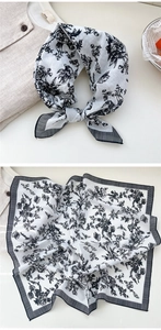 Macro view of vintage floral cotton square scarf with black borders and retro patterns