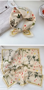 Close-up of lightweight floral cotton scarf with white daisies and yellow borders