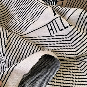 Winter diamond-patterned cashmere-like knit scarf with bold HILL lettering pattern