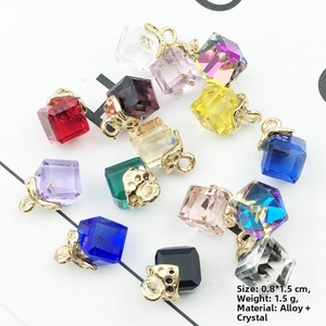 Macro view of multi-colored cube crystal charms with gold alloy hollow bails for DIY jewelry