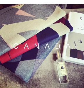 Detail of soft thick cashmere-like scarf with geometric diamond patterns and knit texture