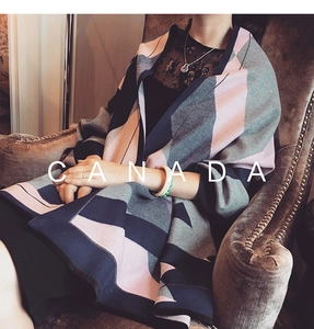 Detail of a thick color block pashmina shawl with pink, grey and navy geometric patterns