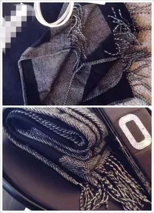 Détail d'une écharpe d'hiver épaisse avec motif chevrons gris et beige et franges