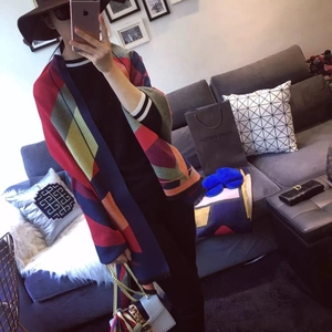 Detail view of thick cashmere-like scarf featuring vibrant geometric color block patterns